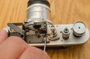 I am pointing to the black sliding lever which keeps the second curtain open when a the slow speed governor is engaged. When the governor is removed, this lever will always prevent the second curtain from closing unless you slide it towards the viewfinder.