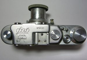An original FED/Zorki camera made in 1948 which shows both the FED and Zorki logos on the top plate. Notice the KMZ logo does not yet show the bent arrow which would later be added to the logo.