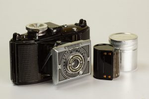 An example of an early AGFA Karat 6.3 with the art deco front panel. Sitting beside the camera is a Karat film cassette and canister.