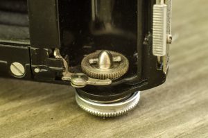 This little catch mechanism senses a hole in 828 film that stops the film advance upon reaching the next frame.