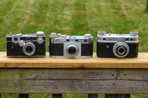 The Clarus next to an Argus C3 and Perfect One oh Two. The Clarus is wider than the Argus, but shorter than either other camera.