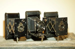 Three different variants of the Vest Pocket Kodak, which was the first camera designed to use 127 film.
