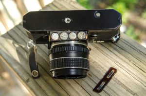 The Pentax ES II has a unique battery compartment beneath the lens mount which takes four S76 batteries.